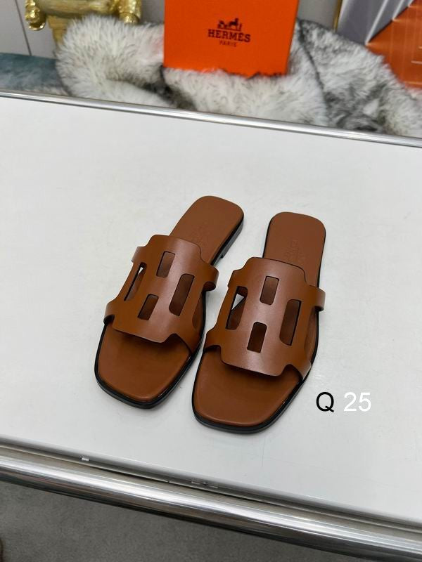 Hermès Oran sandals in Fauve tan calfskin leather with iconic H-strap cutout, displayed with original orange Hermès box